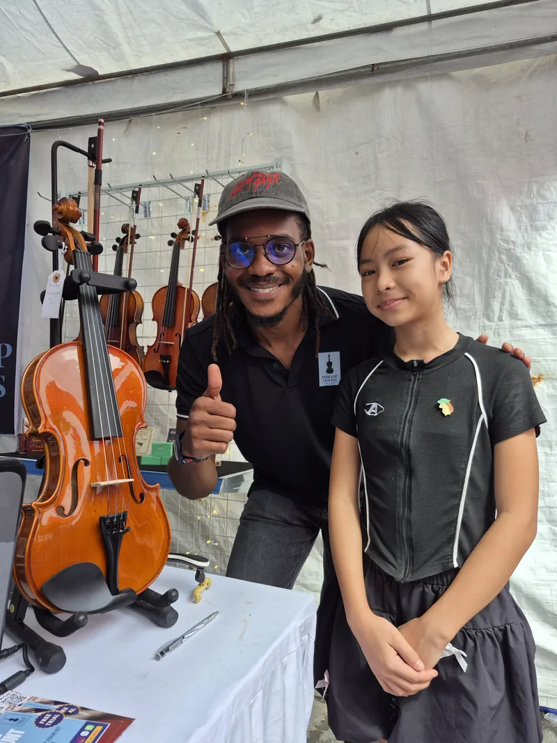 Rahmaan with a young violin student in Da Nang